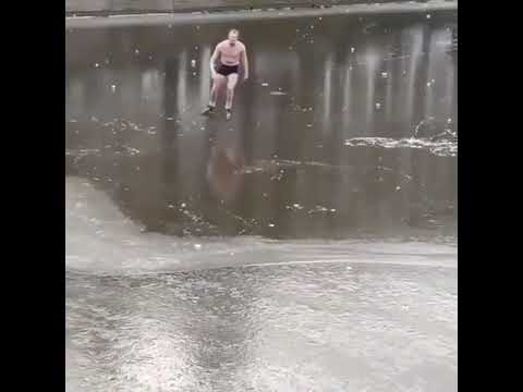 Guy falls into river while ice skating